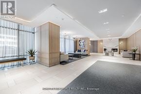Toronto (Bayview Village) condo for rent - A spacious living room with a large window and a wooden floor.