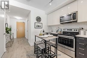 Toronto (Bayview Village) condo for rent - A kitchen with a stove top oven and microwave above it.
