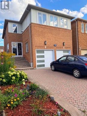 Mississauga (East Credit) apartment for rent - A blue car is parked in front of a brick house.
