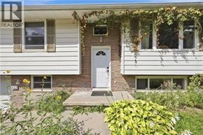 Waterloo apartment for rent - A house with a white door and windows with plants in front.