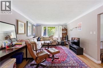 Waterloo apartment for rent - A living room with a rug on the floor and a chair in the middle.