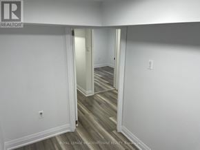 Toronto (Little Portugal) duplex for rent - A hallway with white walls and wood flooring.