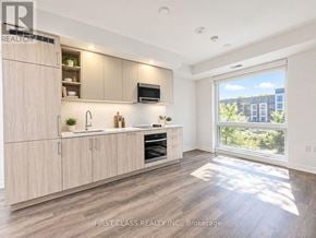 Vaughan (Vaughan Corporate Centre) condo for rent - A modern kitchen with wooden cabinets and a large window.