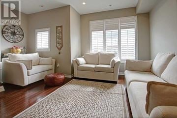 Mississauga (Lakeview) townhouse for rent - A living room with white furniture and a rug.
