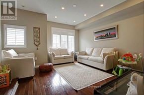 Mississauga (Lakeview) townhouse for rent - A living room with white furniture and a painting on the wall.