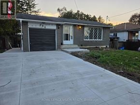 Pickering (West Shore) apartment for rent - A house with a garage and a driveway in front of it.