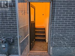 Pickering (West Shore) apartment for rent - A doorway with a bright orange door and a sign that says "REALTOR".