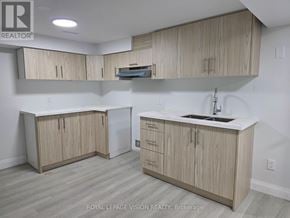 Pickering (West Shore) apartment for rent - A kitchen with wooden cabinets and a white countertop.