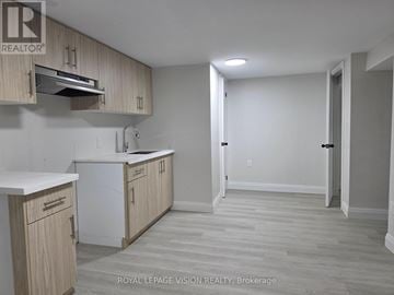 Pickering (West Shore) apartment for rent - A kitchen with wooden cabinets and a white countertop.