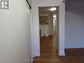 Pickering (West Shore) apartment for rent - A hallway with white walls and wood floors.