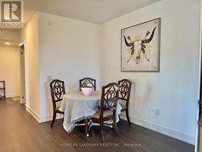 Markham (Unionville) condo for rent - A dining room with a table and chairs and a painting of a bull's head.