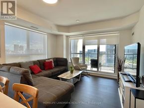 Markham (Unionville) condo for rent - A living room with a grey couch and a wooden chair.