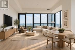 Mississauga (City Centre) condo for rent - A modern living room with a large window overlooking the city.