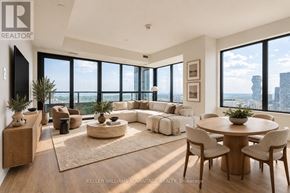 Mississauga (City Centre) condo for rent - A living room with a large window overlooking the city.