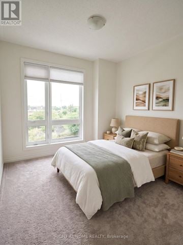 Markham (Victoria Square) townhouse for rent - A bedroom with a large bed and a window overlooking a green landscape.
