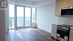 Milton (Tm Timberlea) condo for rent - A kitchen with a stove top oven and microwave above it.