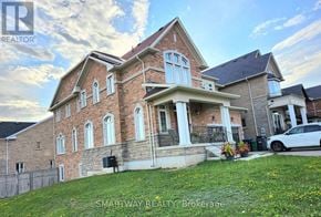 Brampton (Credit Valley) apartment for rent - A large brick house with a white car parked in front.