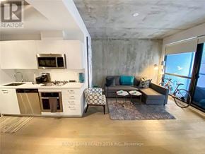 Toronto (Waterfront Communities) condo for rent - A modern kitchen with a large island and a view of the city.