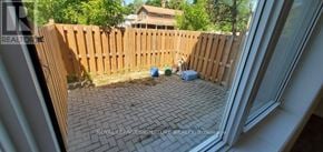 Whitchurch-Stouffville multi-family for rent - A patio with a wooden fence and a brick floor.