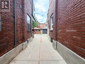 Toronto (Junction Area) apartment for rent - A narrow alleyway between two red brick buildings.