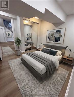 Toronto (Eringate-Centennial-West Deane) apartment for rent - A bedroom with a large bed and a plant.