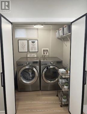 Toronto (Eringate-Centennial-West Deane) apartment for rent - A laundry room with two front loading washing machines.