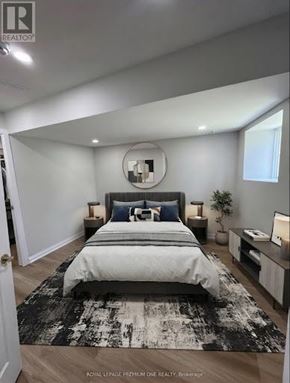 Toronto (Eringate-Centennial-West Deane) apartment for rent - A bedroom with a large bed and a mirror on the wall.