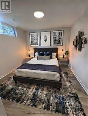 Toronto (Eringate-Centennial-West Deane) apartment for rent - A bedroom with a large bed and a rug on the floor.