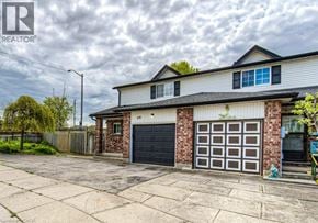 Cambridge townhouse for rent - A two-story house with a garage door and a brick wall.