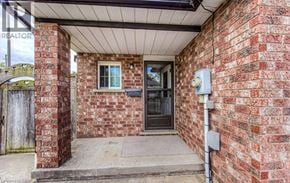 Cambridge townhouse for rent - A red brick house with a sign that says REALTOR.