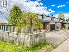Cambridge townhouse for rent - A large house with a wooden fence in front of it.
