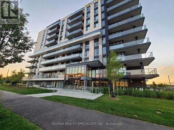 Brantford condo for rent - A modern multi-story building with balconies and glass windows.