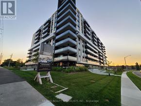 Brantford condo for rent - A large building with a sign in front that says RE/MAX REALTY SPECIALISTS INC. Brokerage.