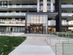 Brantford condo for rent - The entrance to a building with a glass door and a sign that reads "Ambrosia Condos".