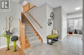 Ottawa apartment for rent - A staircase with a wooden banister and a light brown carpeted runner.