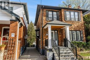 Toronto (Yonge-Eglinton) apartment for rent - A brick house with a porch and a sign that says International Realty.