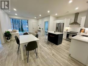 Huntsville (Chaffey) condo for rent - A modern kitchen and dining area with a large island and stainless steel appliances.