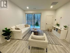 Huntsville (Chaffey) condo for rent - A well-lit living room with a white sofa and a coffee table.