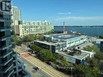 Toronto (Waterfront Communities) condo for rent - A city street with a view of the water and buildings.