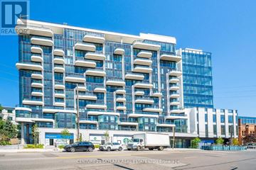 Toronto (Annex) condo for rent - A modern building with a glass facade and a sign that reads "REALTOR".