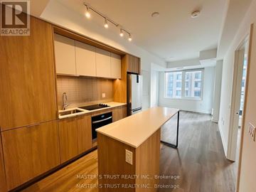 Mississauga (City Centre) condo for rent - A kitchen with wooden cabinets and a countertop is shown.
