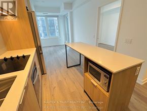 Mississauga (City Centre) condo for rent - A kitchen with a wooden counter and a stove top oven.
