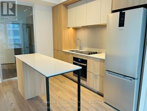 Mississauga (City Centre) condo for rent - A kitchen with a refrigerator, sink, and counter.