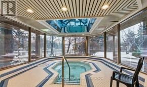 Mississauga (City Centre) condo for rent - A swimming pool inside a room with a glass ceiling.