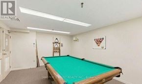 Mississauga (City Centre) condo for rent - A pool table in a room with a brokerage sign.