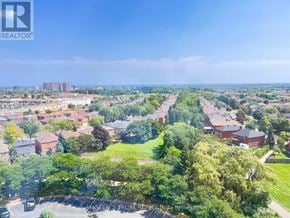 Mississauga (City Centre) condo for rent - A bird's eye view of a residential area with houses and trees.