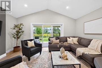 Southwold (Talbotville) apartment for rent - A living room with a grey couch, a black armchair, and a coffee table with a vase on it.