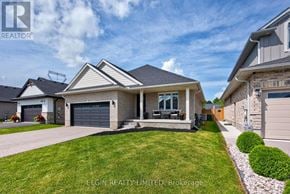 Southwold (Talbotville) apartment for rent - A house with a well-maintained lawn and a clear sky above.