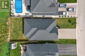 Southwold (Talbotville) apartment for rent - A bird's eye view of a residential area with houses and a swimming pool.