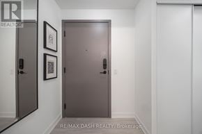 Toronto (Church-Yonge Corridor) condo for rent - A hallway with a brown door and two framed pictures on the wall.